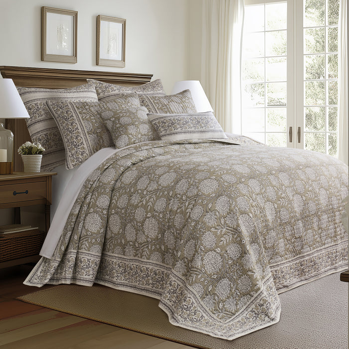 Bedroom with patterned bedding and wooden nightstand