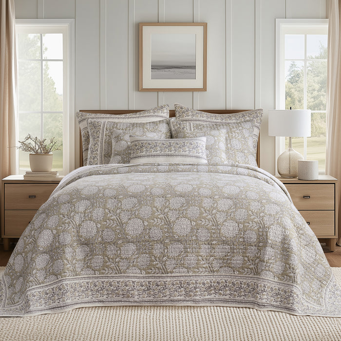 Bedroom with floral-patterned bedding, nightstands, and a lamp.
