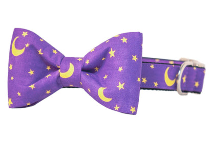 Dog collar and matching bow tie set in rich purple fabric, decorated with bright stars and crescent moons. The large, structured bow tie adds a charming touch, and the hardware provides secure functionality. Ideal for Halloween costumes or pets who love a little magical flair.