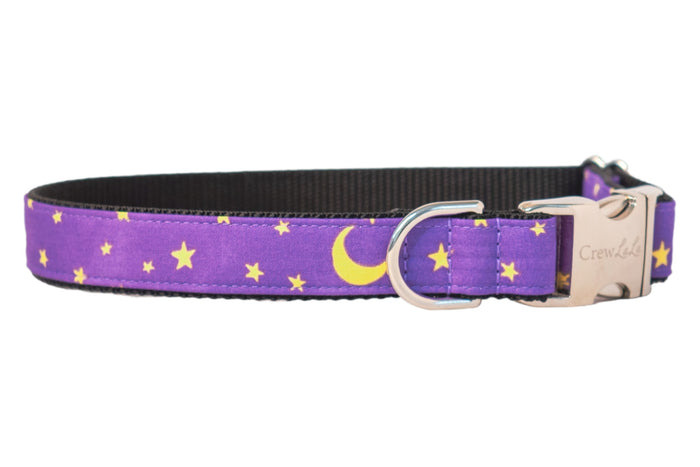 Purple dog collar with a night sky design featuring bright stars and crescent moons, paired with polished hardware and a sleek nylon webbing lining. This dreamy, magical accessory is perfect for dogs celebrating Halloween or just looking stylish under the moonlight.