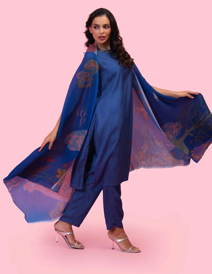 Model wearing the 'BRAHMAND BLUE' kurta set with a straight-fit Dola silk kurta, matching pants, and a statement printed georgette cape.