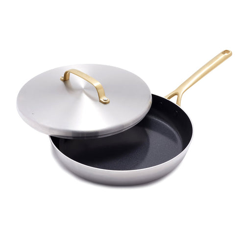 Stainless steel 12-inch frypan with lid, champagne-colored handles, lid partially open on a white background.