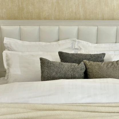 White duvet cover with gray accent pillows, bed-ready set