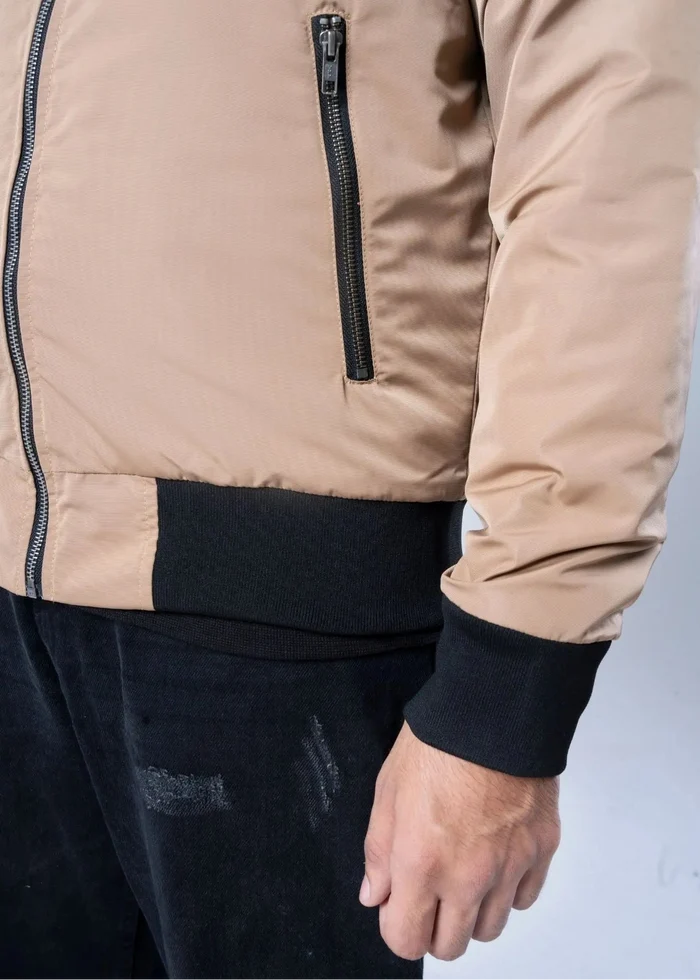 Men's winter memory jacket close-up: khaki front zip, black pocket trim.