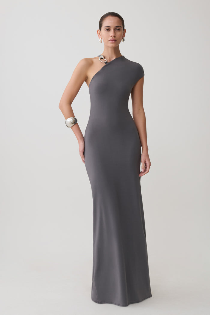 Woman wearing a grey slinky maxi dress with hardware.