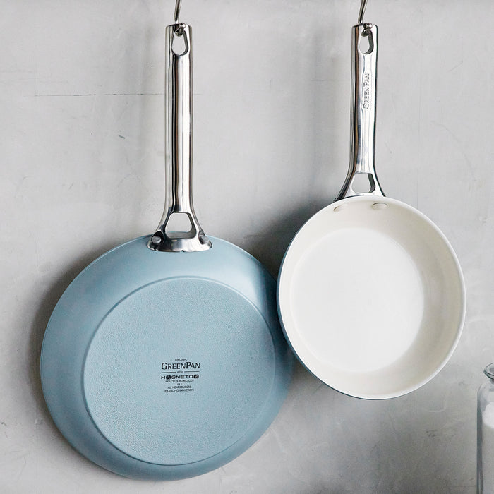 Set of two ceramic nonstick frypans, 8-inch and 10-inch, in gray, hanging on a wall.