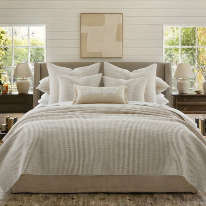A beautifully styled bed featuring the Pick-Stitch Artisan Square Pillow and a cozy, inviting decor.