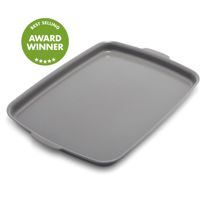 Gray ceramic nonstick half sheet pan with handles, 18x13, shown with a green badge on the corner.