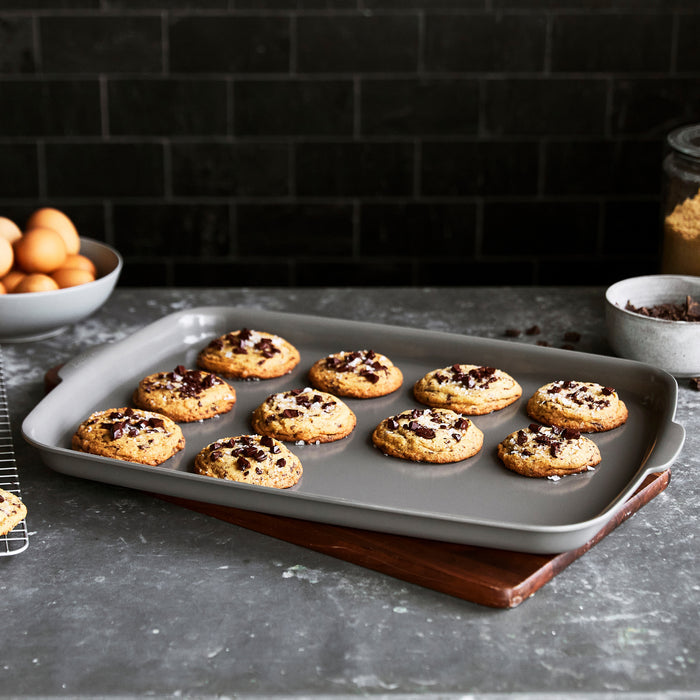 Gray ceramic nonstick half sheet pan, 18x13 inches, shown on a plain background.