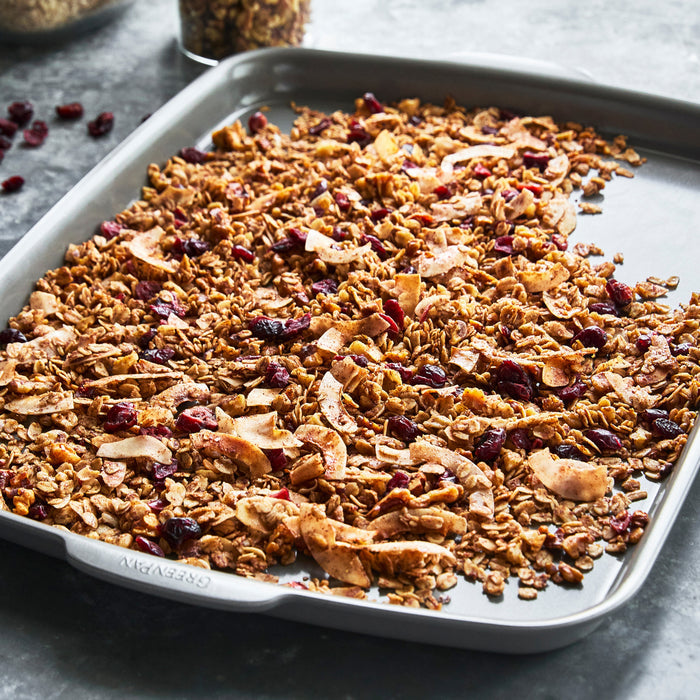 Ceramic nonstick half sheet pan, 18x13 inches, with homemade granola spread on top.