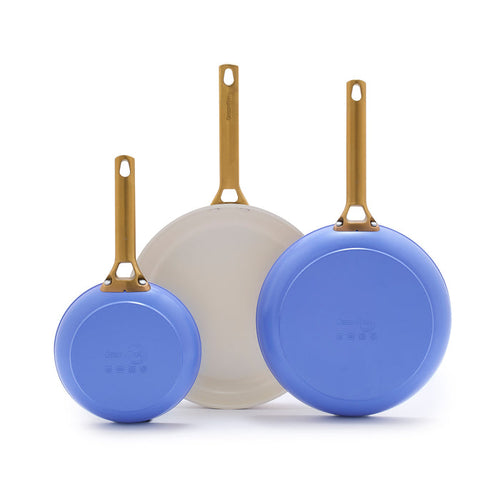 Set of three ceramic frying pans with gold handles: two blue and one white. Sizes are 8, 10, and 12.