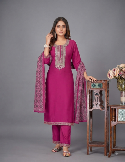 Model wearing an elegant rose pink solid silk straight kurta suit set with intricate traditional embroidery on the neckline, paired with matching pants and a detailed dupatta.