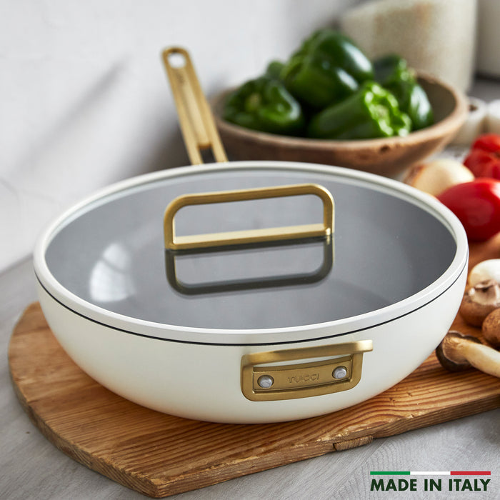White ceramic 6.5-quart pan with gold handle, single piece shown on a white background.
