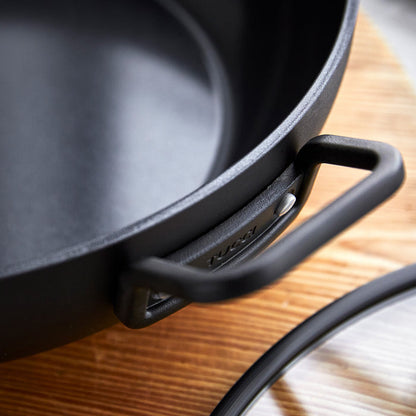 Black ceramic nonstick pan with lid on a wooden surface, 6.5-quart size, single piece shown.
