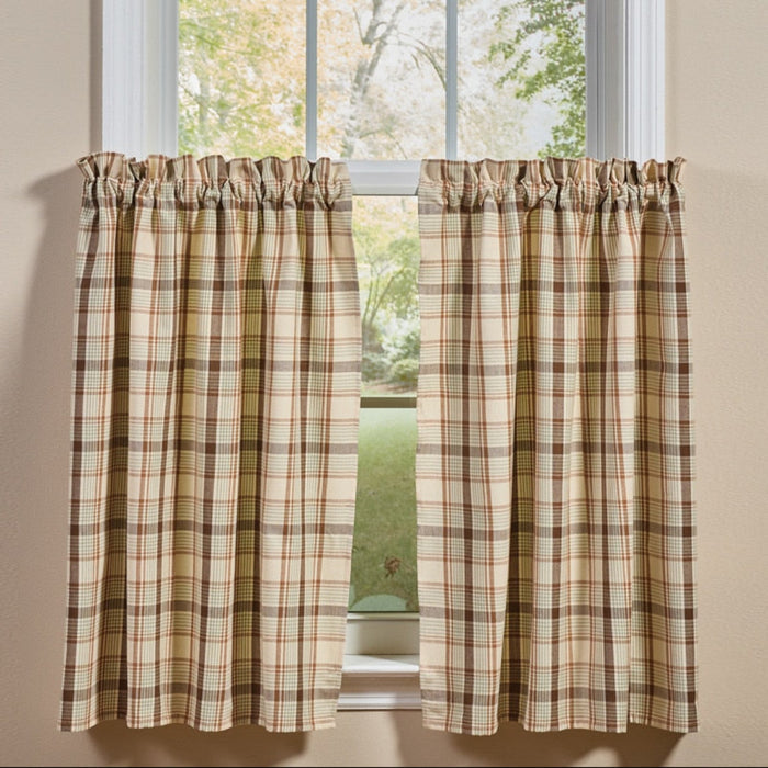 Toffee & Elm Plaid Cafe Tiers two tier panels in a beige green and brown plaid pattern, shown hanging on a white window frame against a beige wall.