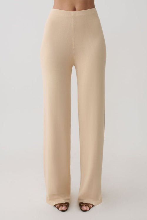 Woman wearing beige knit pants.